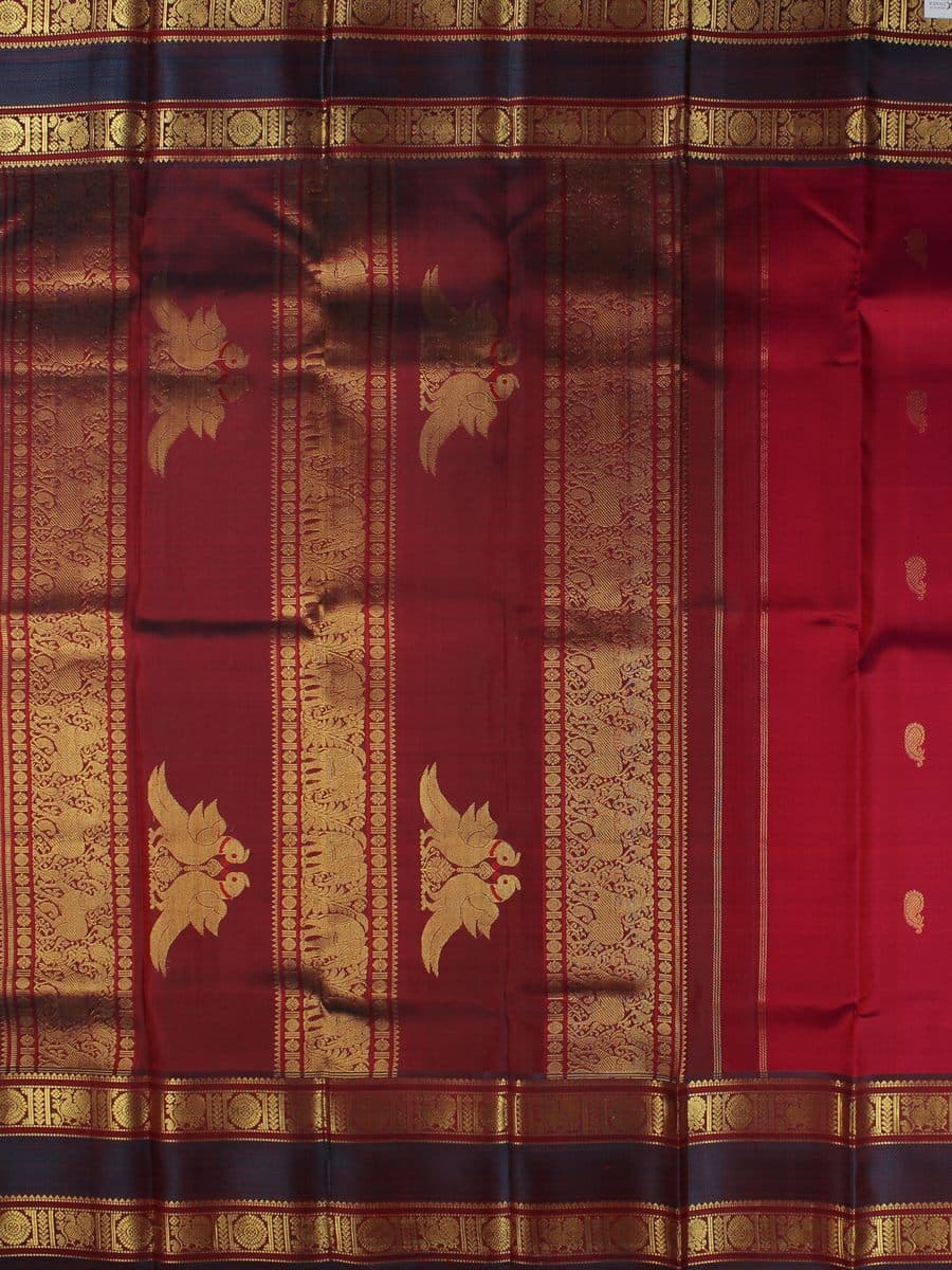 Detail of Kanchipuram pure silk in deep burgundy, with a broad antique gold zari border
