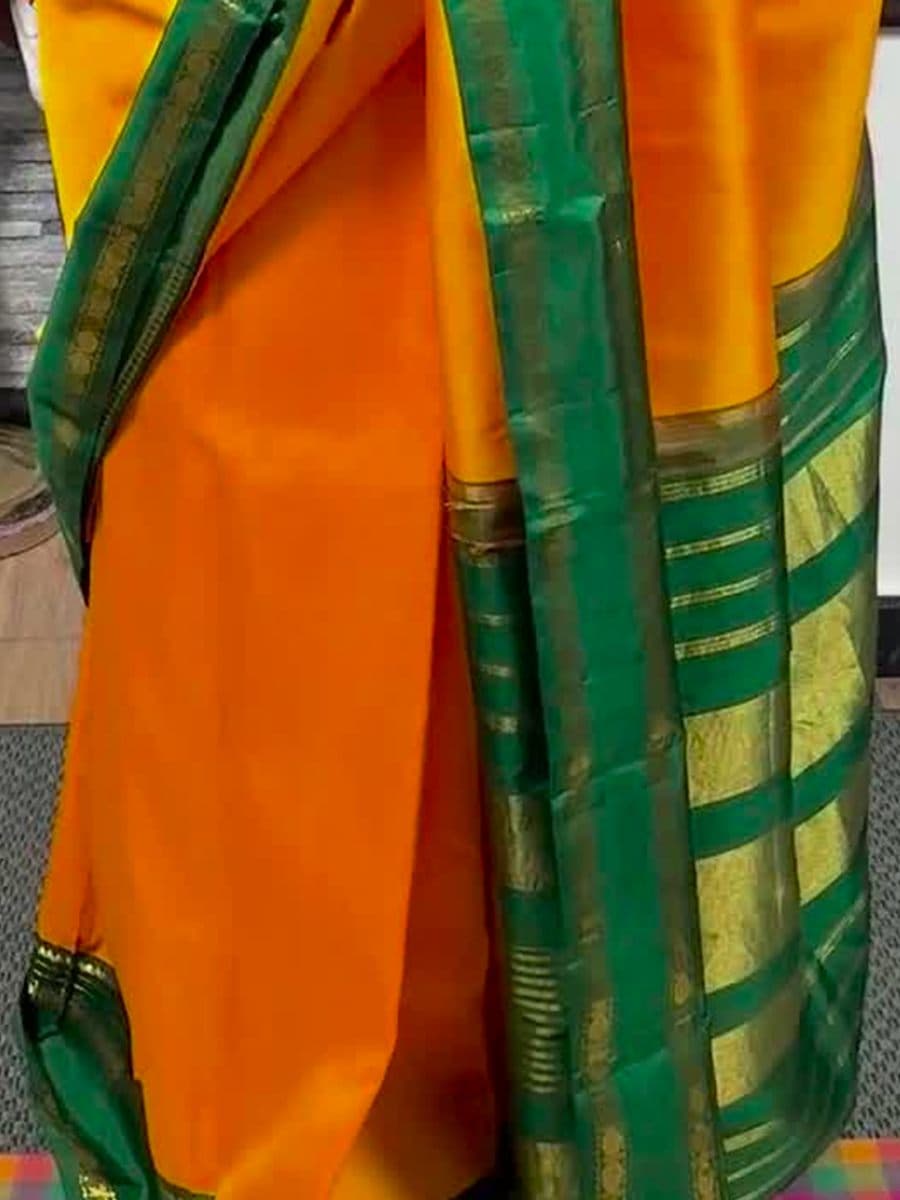 Detail of a Thirubhuvanam temple weave in deep green, with a gold korvai border of temple-spire motifs